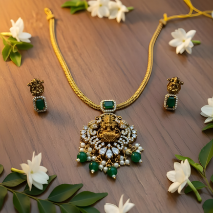 Antique gold Lakshmi necklace with green stones and matching earrings