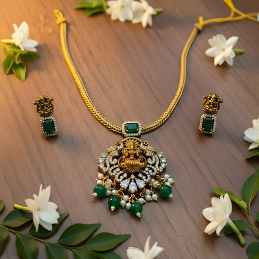 Antique gold Lakshmi necklace with green stones and matching earrings
