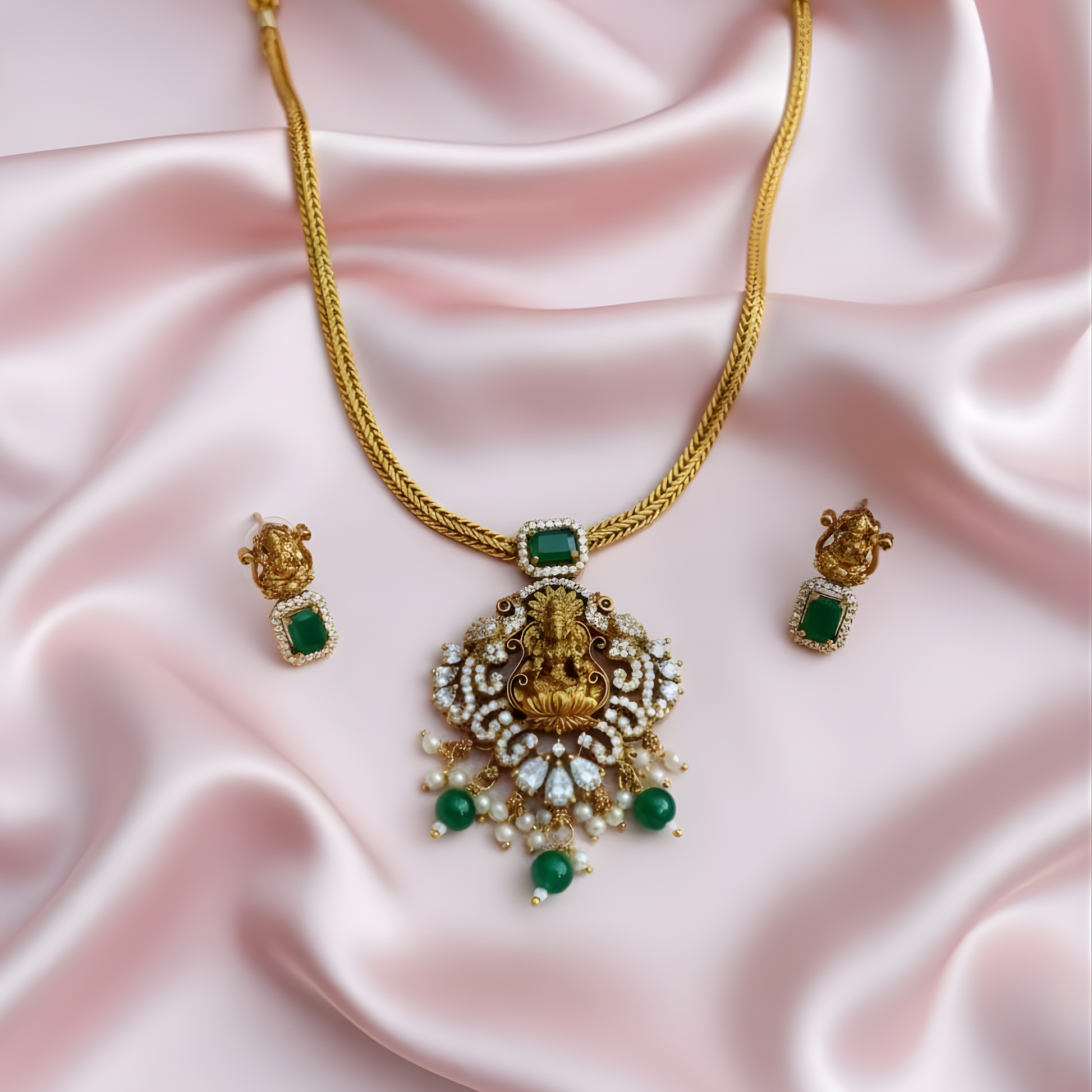 Antique gold Lakshmi necklace with green stones and matching earrings