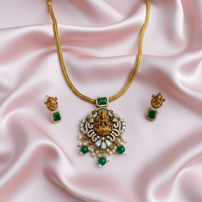 Antique gold Lakshmi necklace with green stones and matching earrings