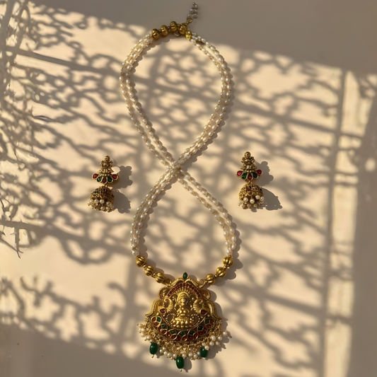 Antique gold Lakshmi temple necklace with pearl strands and matching jhumkas